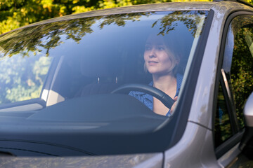Young woman is driving a car. Car travel, lifestyle concept