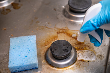 Dirty stove with food leftovers. Unclean gas kitchen cooktop with greasy spots, old fat stains, fry...