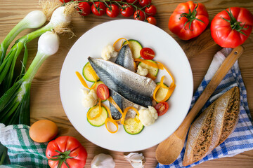 Baked mackerel with delicious and healthy vegetables. Top view table.