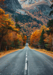A scenic drive through a mountain pass with autumn trees on both sides of the road.