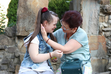 A mother walks with her daughter with Down syndrome.