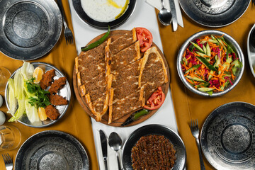 Top view, traditional Turkish cuisine and table setting, traditional pide, food service, appetizers and dishes.