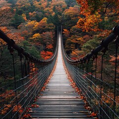 Fototapeta premium Suspension bridge in a valley with autumn leaves (Tochigi, Japan)