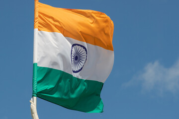 Flag of India fluttering against blue sky. Flag of India, national symbol of India. Flag of India...