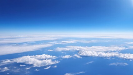 Aerial view of the fluffy clouds on blue sky.
