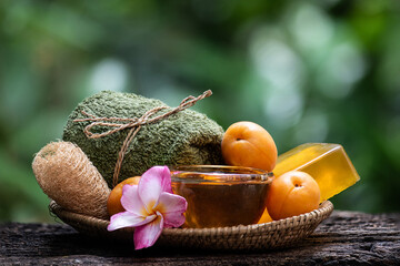 Glycerin soap mixed with apricot extract and honey on natural background.