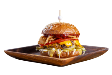 Big tasty burger with fried cutlet, cabbage salad, tomatoes and sauce on wooden plate isolated on white background.