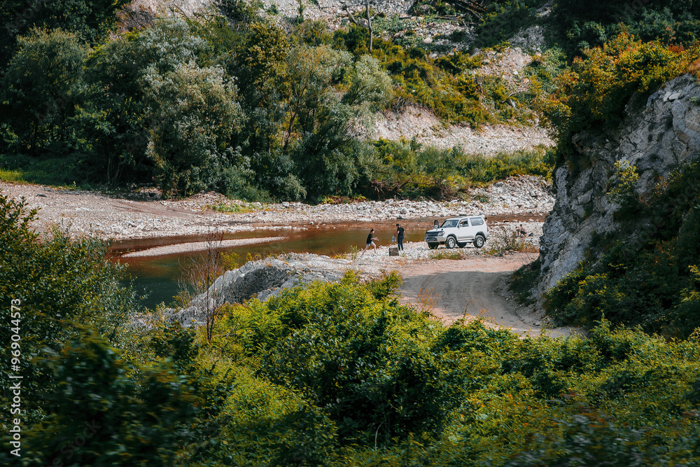 Wall mural a summer landscape with a river and mountains. the river flows through the valley of the caucasus mo