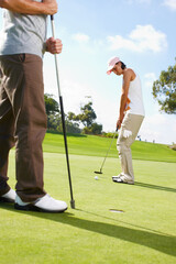 Obraz premium Hole, game and couple on golf course with club, outdoor fun and fitness on weekend morning together. Ball, woman and man on green grass for nature sports, challenge and competition with exercise