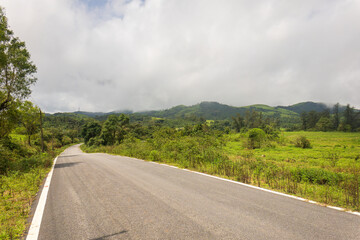 A long road leading towards mountains