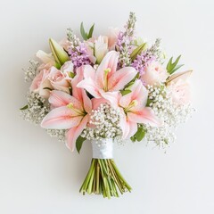 A beautiful bouquet of pink lilies, roses, and greenery arranged for decoration or gifting.