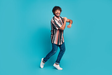 Full size photo of nice young man dancing wear shirt isolated on teal color background
