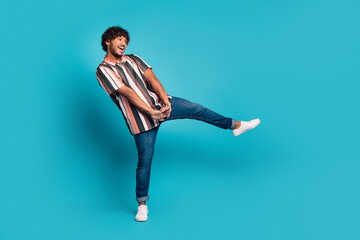 Full size photo of nice young man good mood dancing wear shirt isolated on teal color background