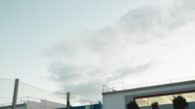 Female basketball player in morning light on professional court running with ball and thowing ball to the net. Handhelded footage. Outdoors. Basketball student female player at university 