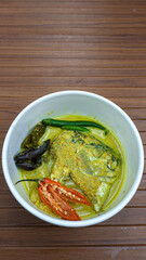 Semar fish head curry. Culinary delights with Indonesian spices. Semar fish (Mene maculata) cooked in yellow curry sauce with a spicy and savory taste typical of Minangkabau.