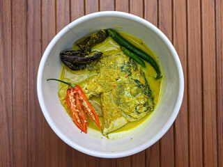 Semar fish head curry. Culinary delights with Indonesian spices. Semar fish (Mene maculata) cooked in yellow curry sauce with a spicy and savory taste typical of Minangkabau.