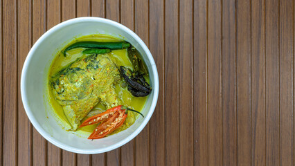 Semar fish head curry. Culinary delights with Indonesian spices. Semar fish (Mene maculata) cooked in yellow curry sauce with a spicy and savory taste typical of Minangkabau.