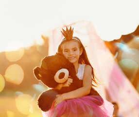 Portrait, princess or girl with teddy bear in park for love, orphan or toy for support, care or...