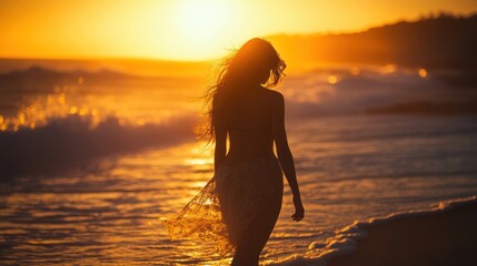 Fototapeta premium A silhouette of a woman walking along the beach at sunset, capturing a serene moment.