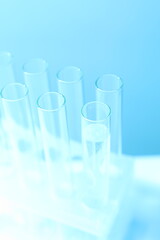 Laboratory test tubes on colored background