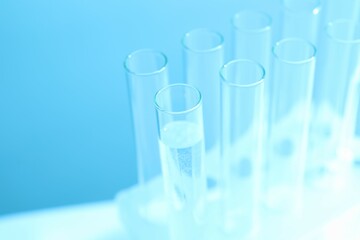 Laboratory test tubes on colored background
