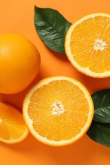 Summer tropical composition with a wooden frame. Green leaves and tropical orange fruits on a colored background. Summer concept. Flat lay, top view, copy space