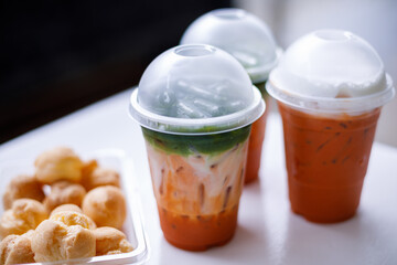 Mixed Iced Thai Tea And Green Tea in Glass on Table