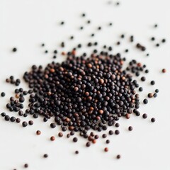 A pile of small black seeds on a white surface.