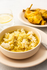 Stewed rabbit with rice, served table with food, delicious hearty lunch or dinner