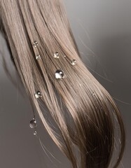 a strait and smooth hair isolated on background for hair care with a shampoo and flowers