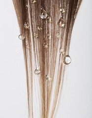a strait and smooth hair isolated on background for hair care with a shampoo and flowers