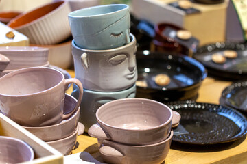 Various ceramic mugs and plates at a street market
