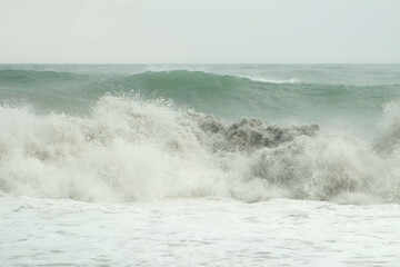 Sea storm, power of huge crushing waves water, nature and seascape with foam in overcast weather. Power of water, nature and seascape on coast. Splashing natural big waves on coastline.
