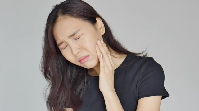 Asian woman suffering from toothache, tooth decay, tooth sensitivity, wisdom tooth pain, cavity, dental care concept