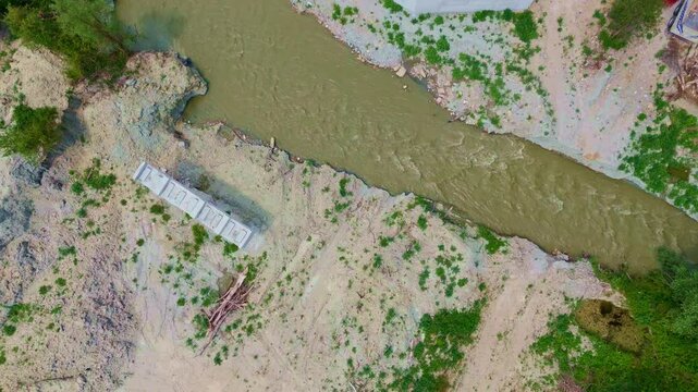 Aerial view a river with a bridge.