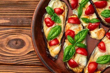 Italian mini pizza . Aubergine (eggplant ) with mozzarella cheese and basil . On rustic background