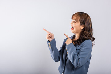 Obraz premium Woman excited smiling makes finger two gun gesture to camera isolated white background, Happy Asian portrait beautiful young female says you are chosen ll kill you or what up man with cheeky