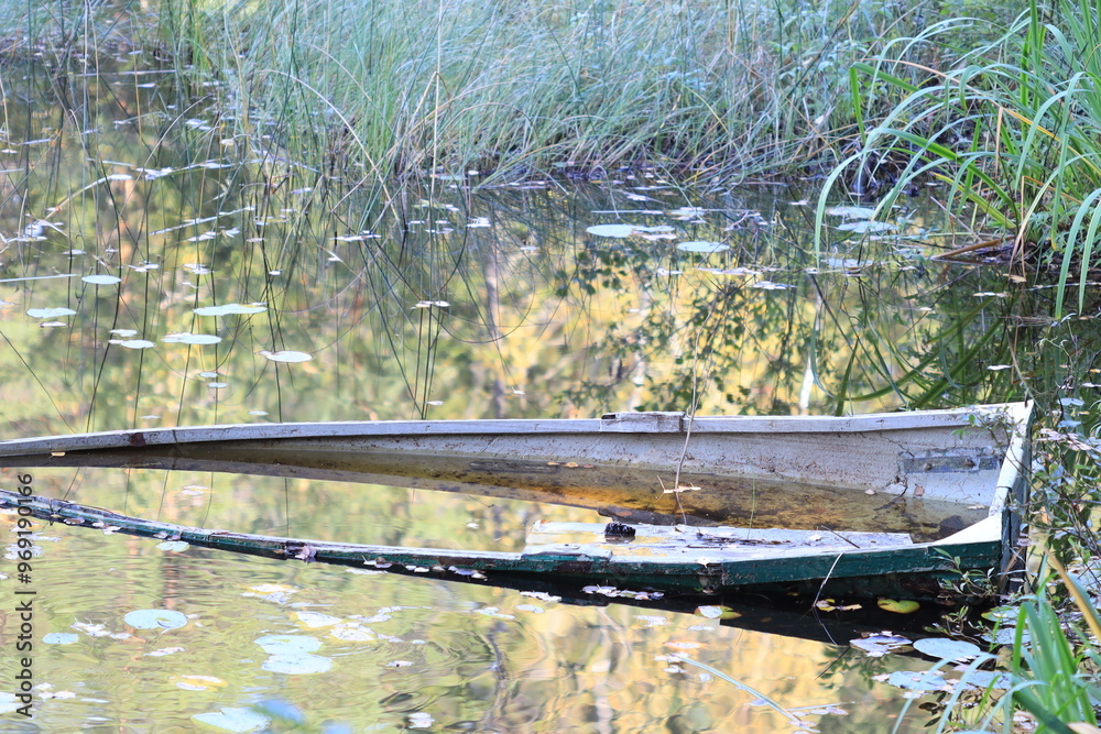 Poster a small boat floating on calm water with no signs of movement or activity