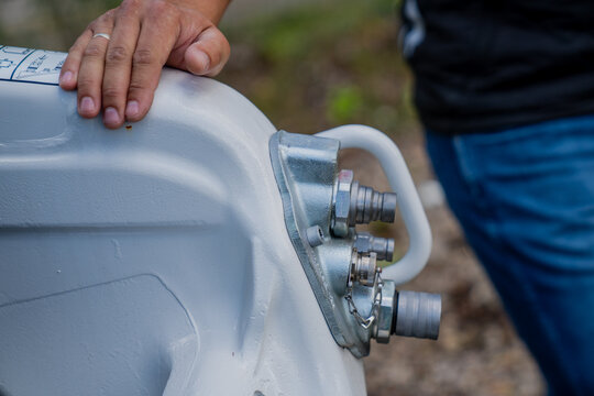 Mechanic holding hand of mechanical exterior of metal carcas for a construction lift heavy equipment machinery