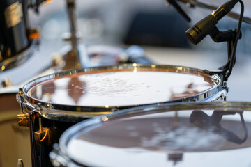 Drums set up on an open-air concert stage, ready for live performance