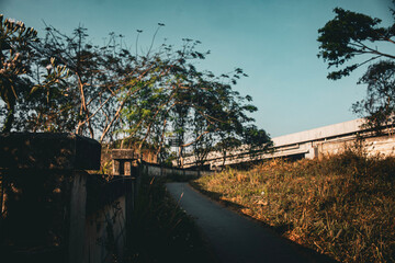 Uphill road on a bright morning with clear blue sky