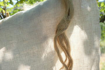 Bast fiber, and linen fabric in the sunlight garden. Growing demand for natural fibers. Copy space.