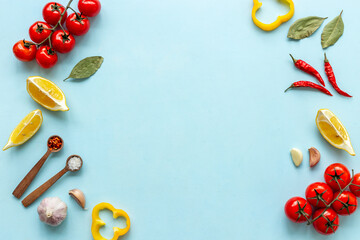 Cooking frame with tomatoes cutting vegetables and spices, top view. Menu concept