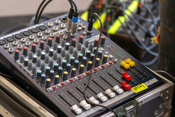 Sound control equipment positioned on the concert stage, used for managing audio levels and ensuring high-quality sound during live performances and events
