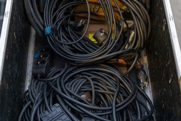 Pile of industrial cables on the concert backstage, ready for use in live performances and event production