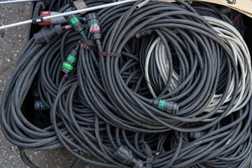 Pile of industrial cables on the concert backstage, ready for use in live performances and event production