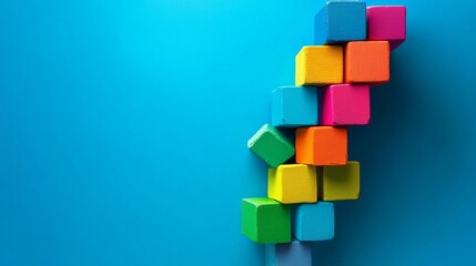 Obraz premium Colorful wooden blocks stacked on blue background