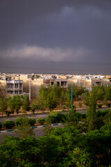 Obraz premium Dark clouds over a city just before the rain in Yazd, Iran. 