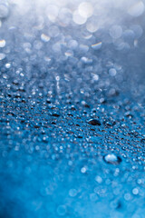 Scattering waterdrops on blue glass