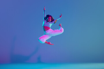 Youthful energy, dynamic hip hop choreography. Young talented and artistic girl performing against...